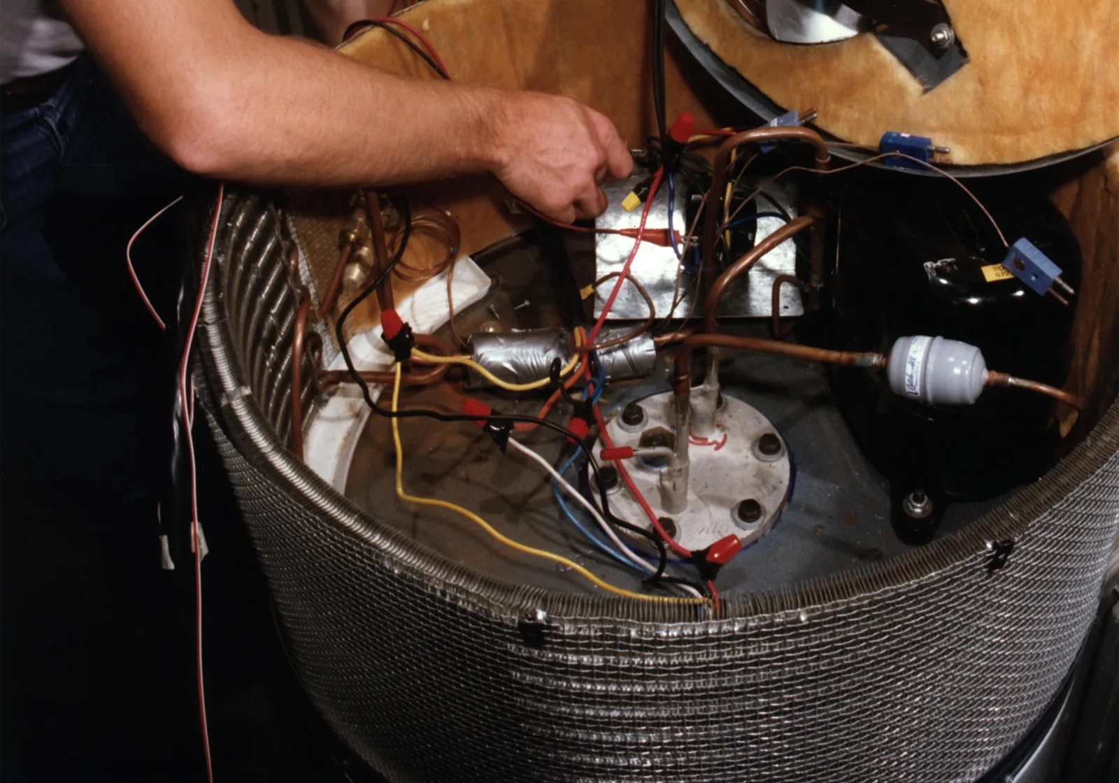 Compressor and refrigerant tubing inside a heat pump water heater's heat-pump module