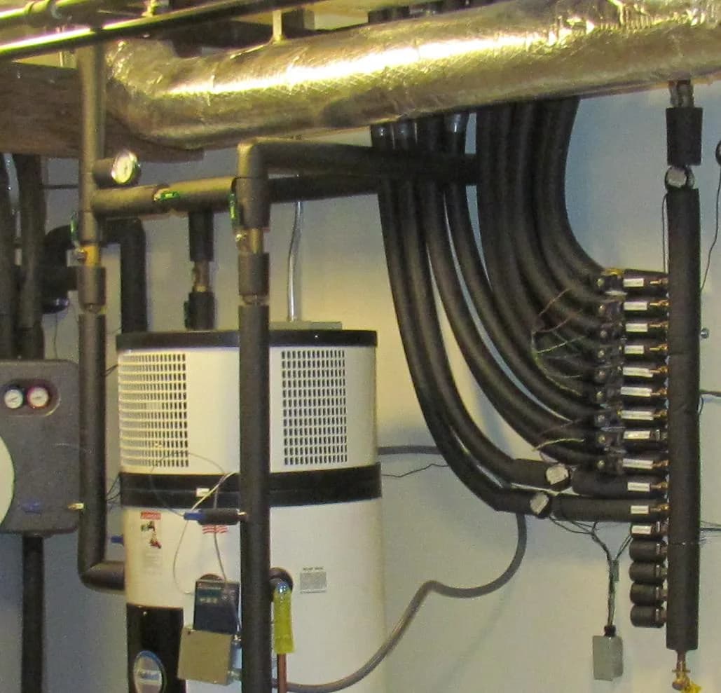 Heat pump water heater with a fan-topped module connected to a manifold of mechanical room piping